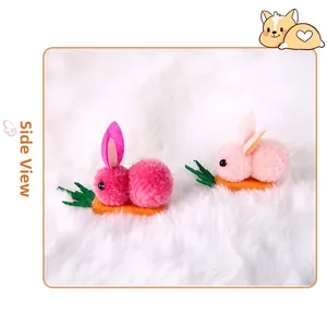 Side view of cute pink plush bunny hair clips with orange carrot details for Easter