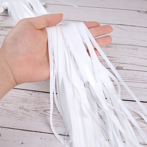 Close-up of white tinsel foil fringe curtains for Halloween party background decoration