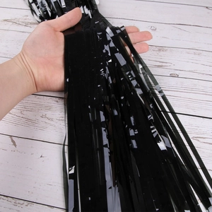 Detailed view of shiny black foil fringe curtain for Halloween party background decor