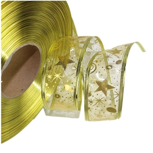 Close-up of golden metallic texture ribbon and sheer organza band with gold star patterns