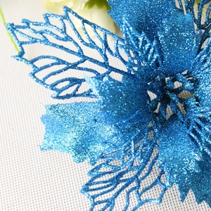 Macro shot of blue glitter hollow Christmas flower decoration with sparkling petals