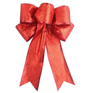 Detail of a large red glitter Christmas bow featuring long tails and shimmering texture