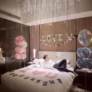 Silver foil fringe curtain with LOVE letter balloons and party decorations for birthday events
