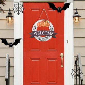 Detail of wooden Halloween welcome sign with orange pumpkins and purple Welcome text