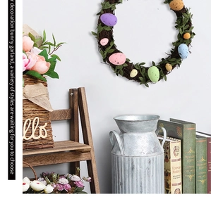 Close-up of Easter wreath with colorful eggs and green leaves on natural rattan base