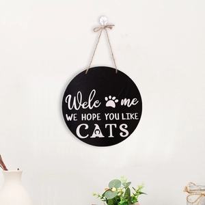 Detail of wooden welcome sign with cat paws and we hope you like cats quote