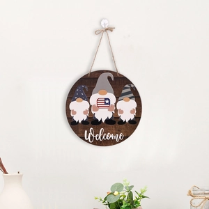Detail of wooden gnome welcome sign with American flag elements and rustic twine hanger