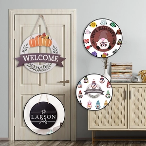 Detail of wooden welcome door sign with pumpkin wreath and gnome decorative designs
