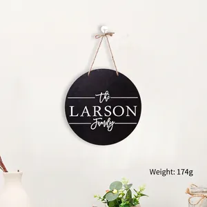 Hanging round wooden Christmas sign with personalized name and natural twine cord