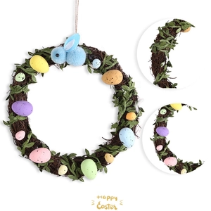 Detail of Easter rattan wreath with colorful speckled eggs, green leaves and plush bunny