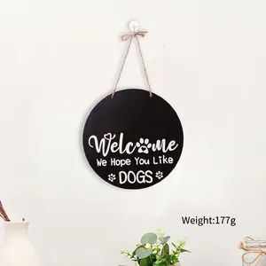 Detail of wooden welcome sign for dog lovers featuring rustic paw prints and hanging rope