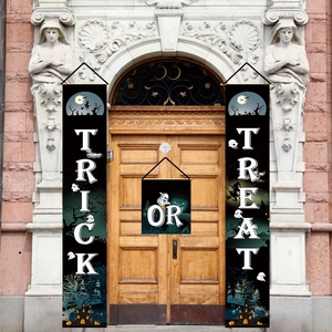 Halloween trick or treat porch banners with pumpkin and ghost motifs on a classic door