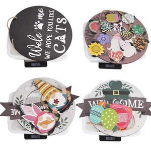 Detail view of interchangeable wooden holiday door signs on scales for weight reference