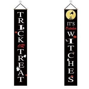 Close-up of Halloween porch banners featuring pumpkin, ghost and witch hat graphics