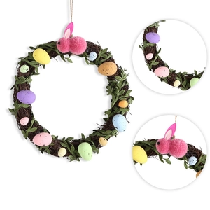 Easter wreath with rattan base, colorful spotted eggs and a pink plush rabbit decoration