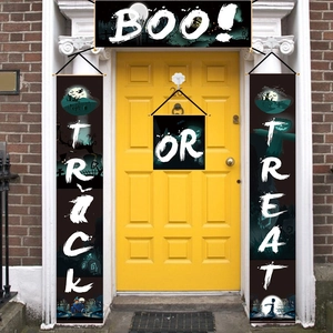 Macro view of Halloween Trick or Treat door banner banners set on a yellow door porch