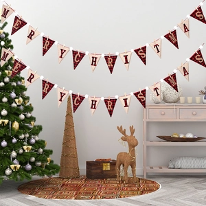 Detail of red buffalo plaid Merry Christmas banner with white pom poms for festive decor