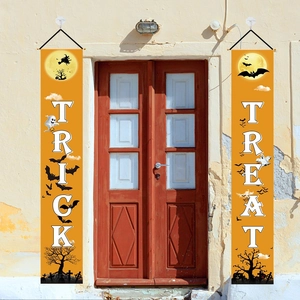 Detail view of orange Halloween banners featuring Trick or Treat text on front doors