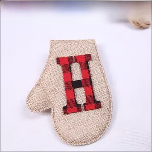 Detail of burlap Christmas glove ornament featuring red and black plaid letter H design