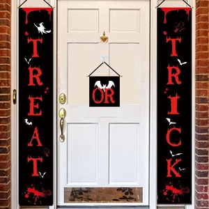 Detail of Trick or Treat Halloween door banners with bat and blood prints on white door