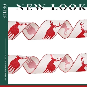Detail of Christmas ribbon with red reindeer print on white polyester satin fabric