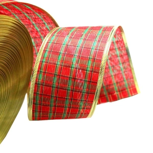 Macro view of red and green plaid Christmas ribbon with gold wired edges on white background