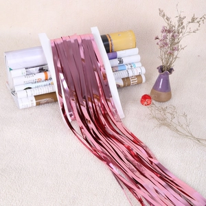 Rose gold metallic foil fringe curtain for party wall decoration on white cardboard