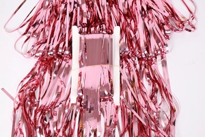 Macro shot of rose gold foil fringe curtain on cardboard for party backdrop decoration