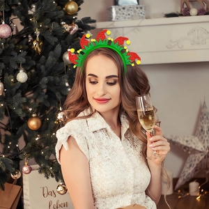 Festive Christmas party headband with red green glitter design on a holiday background