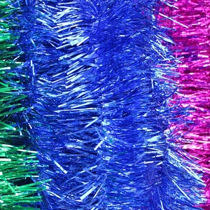 Close-up of blue green and pink metallic tinsel garland for festive party decorations