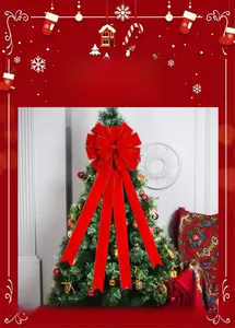 Close-up of red velvet Christmas bow with gold edges and long hanging ribbons
