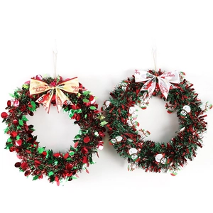 Set of two Christmas wreaths with red berries, mini snowmen, and festive bow ties