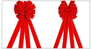 Detail of red velvet Christmas bows with gold glitter edges and long hanging ribbons