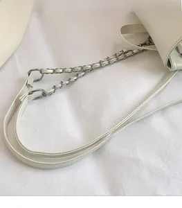 Detail of a creamy white PU leather strap with an elegant silver metal chain link design