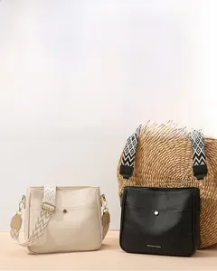 Detail of lychee pattern leather crossbody bag with wide jacquard geometric strap