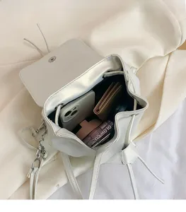 Internal view of white PU bucket bag showing ample space for phone, wallet and cosmetics