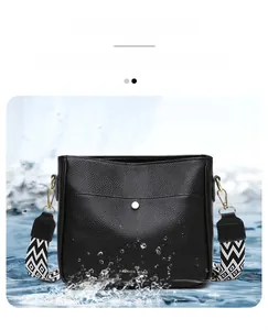Close-up of waterproof black lychee pattern crossbody bag with splash effect