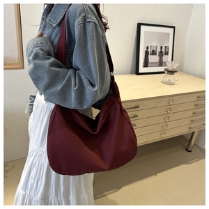 Burgundy minimalist large canvas shoulder bag styled with casual denim and layered white skirt