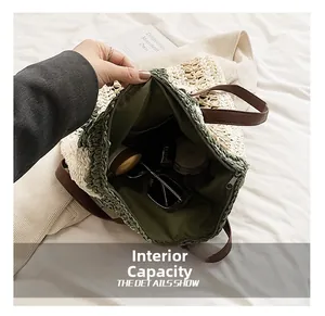 Detail view of the spacious inner compartment with zipper of the straw shoulder bag