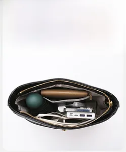 Top view of spacious polyester handbag interior with zipper pocket and everyday essentials