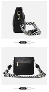 Detail view of black crossbody bag side and back with geometric pattern wide strap