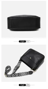 Detail view of black lychee grain crossbody bag with geometric wave pattern strap