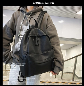 Close-up of a stylish black pebble grain leather backpack with durable zipper detail