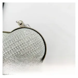 Detail of silver sequined heart crossbody bag showing glittery material and metal ring