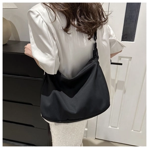 Minimalist black large capacity hobo shoulder bag with wide strap on model