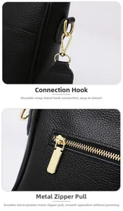 Close-up of pebble leather texture with golden hardware hooks and smooth zipper detail