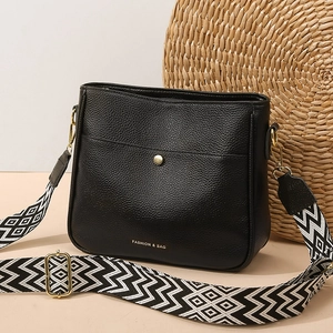 Fashionable black pebbled leather crossbody bag with ethnic geometric wide strap