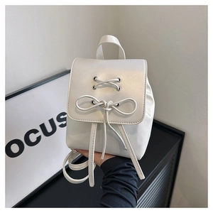 Minimalist white PU leather backpack with decorative bow and silver eyelet details