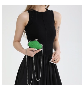 Close-up of cloud-shaped green sequin evening clutch bag with silver chain and metal clasp