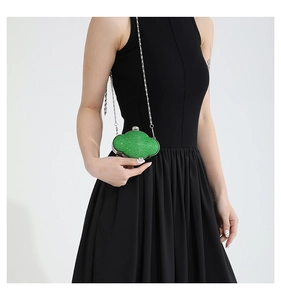Detail of green sequin cloud clutch bag with silver sphere clasp and metal chain